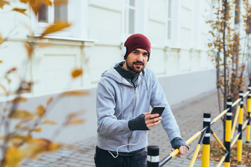 young man jogger using mobile phone, jogging outdoor