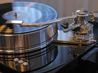 Audiophile HiFi turntable player with musical vinyl record.