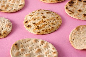  Handmade matzah for Jewish Passover on pink background