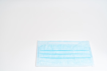 Surgical mask with rubber ear straps. Typical 3-ply surgical mask to cover the mouth and nose. Procedure mask from bacteria. Protection concept.