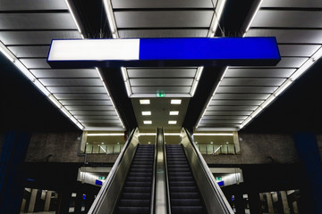 Underground subway architecture. Train station platform. Grunge urban background. Moving staircase escalator.