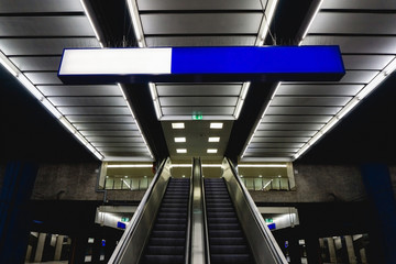 Naklejka premium Underground subway architecture. Train station platform. Grunge urban background. Moving staircase escalator.