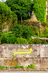 Fisterra road marking on the Fisterra-Muxia Way, Ponte Sarela or Sarela Bridge wall in Santiago de Compostela, A Coruna Province, Galicia, Spain