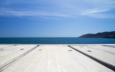 sea and wooden platform with mountain
