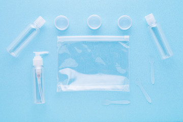 travel toiletries, small plastic bottles for hygiene products on blue background