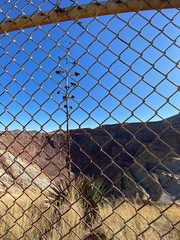 View of deserted Queen Mine through wire fence in Bisbee Arizona