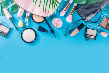 Professional makeup cosmetic set, with summer tropical leaves, woman bag. Make up items. luxury decorative cosmetics flatlay, top view, mockup. Beauty blogger concept. Trendy turquoise background