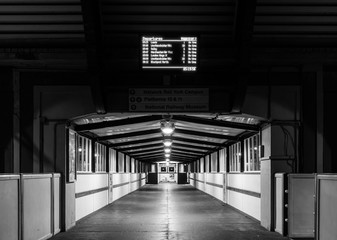 A station walkway at night.