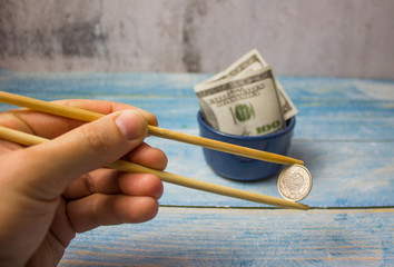 There's a coin in the chopsticks