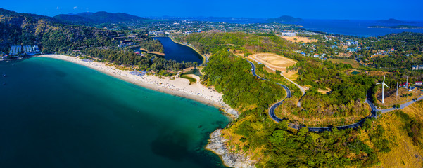 Aerial panorama of the island of Phuket during sunny day. Area of the Nai Harn beach and wind generator. Thailand