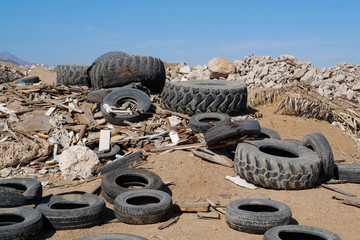 Old tyres and construction waste on landfill