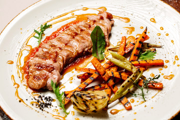 Delicious sliced grilled duck breast with fresh sauce.  closeup of professionally prepared food. top view from above