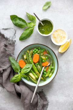 Detox vegetable spring soup, green minestrone inspired recipe, overhead view on ready to eat dish