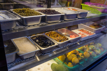 Chinese street food. Street trading. Chinese kinds of fresh seafood at an asian seafood market in Sanya, Hainan province, China. Inscription: name food.