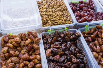 store counter with dried fruits. In plastic containers, the fruits of dried dates. Healthy food. natural nutrition. Vegetarian Products