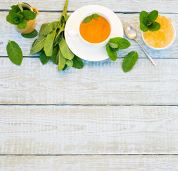 Mint Tea in White Mug. Herbal Tea of Fresh Green Mint Leaves Cup and Crystal Sugar on Rustic wooden Table. Alternative medicine. Traditional herbal therapy. Phytotherapy Medicinal Herbs. Copy space