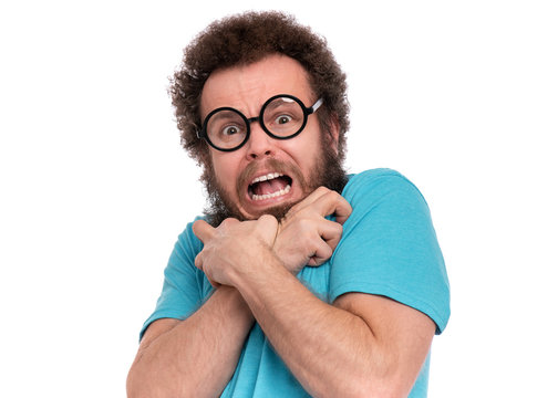 Crazy Scared Man with funny Curly Hair in Eyeglasses looks worried. Bearded guy afraid and shocked, isolated on white background. Emotions and signs concept.