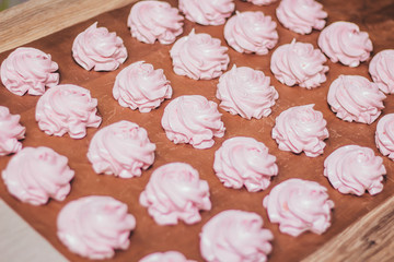 Pink, sweet, tasty, cherry or strawberry marshmallows lies on the table. Beautiful dessert. A large number of marshmallows. Homemade marshmallows. Cooking