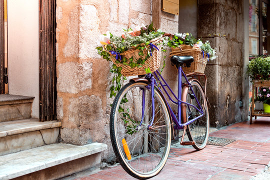 Vintage bicycle with basket full of flowers