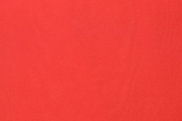 Chiffon coral color. Material on a horizontal surface. Fabric sample.