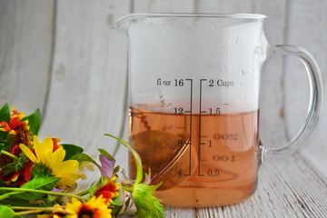 Brewed wellness tea with floral arrangement