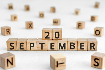 September 20 - from wooden blocks with letters, important date concept, white background random letters around