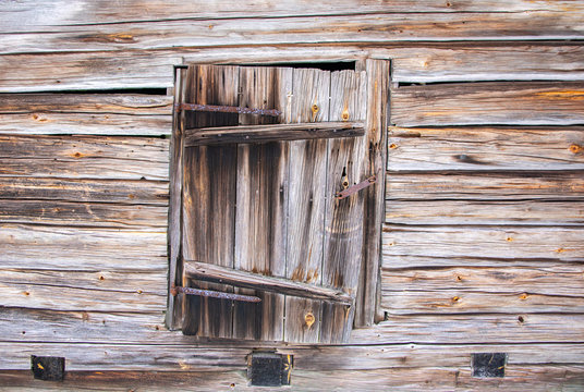 Wall and door of a wooden log house with natural textures