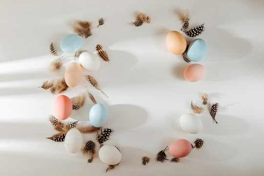 Natural Colored brown, quail and white Eggs with sunlights. Compositions in pastel colors. Easter consept.  Flat lay, top view .