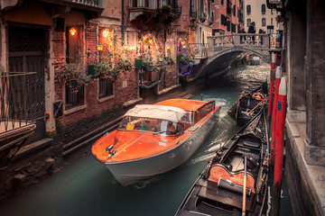 water taxi travelling along a narrow veince canal