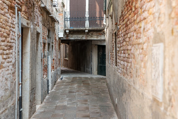 Fototapeta na wymiar A narrow, deserted Venetian street. Copy space.