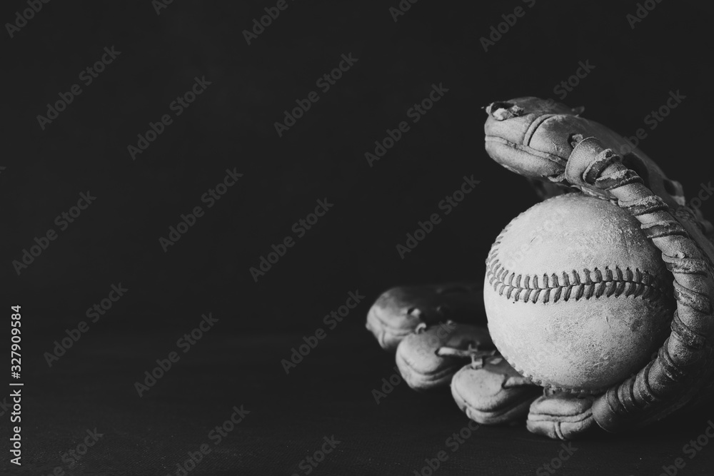 Poster Isolated baseball and glove on black background. - Posters