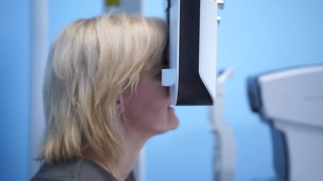 The doctor checks the eyesight of the patient. Foropter electronic automatic. Eye clinic. Health prophylaxis.