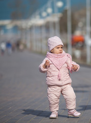 Little girl on a walk on the street. Family.