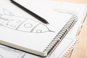 Artist drawing an anime comic book in a studio.