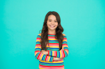Fototapeta premium Happy childrens day. Childhood concept. Little girl turquoise background. Shopping day. Items for small girl. Nice time to be child. Kid fashion. Smiling school girl. Kid long hair. Happy child