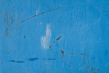 Background. The metal surface of the garage, covered with blue paint. 