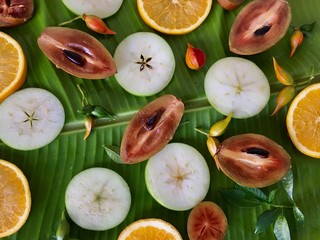 Background of fresh tropical exotic fruits on the banana leaf.