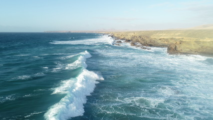 Relax contemplatin the breaking of the waves and the mountainous horizon