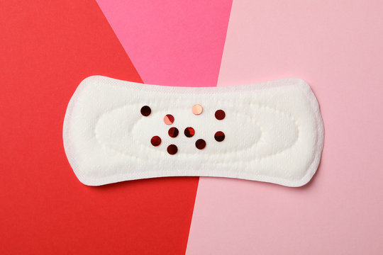 Sanitary Pad With Glitter On Multicolor Background, Top View