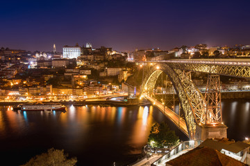 Fototapeta na wymiar Night View of Arched Luis I Bridge Carrying Low Level Road and a High Level Metro Line Between Porto and Vila Nova de Gaia Cities in Portugal