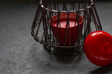 Red Apple candle on a dark background. Interior design