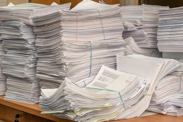 bundles bales of paper documents. stacks packs pile on the desk in the office