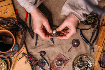handmade copper wire working tools on the table with accessoires. handicraft people art concept