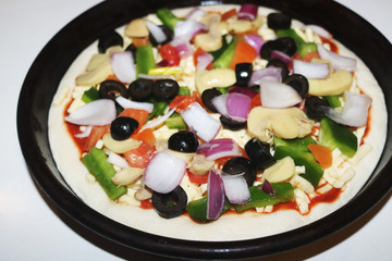 close up image of before bake pizza