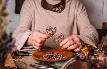 handmade copper wire working tools on the table with accessoires. handicraft people art concept