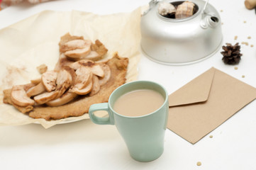 Pie, envelope, seashells, potter and coffee cup on white wooden table. Flat lay food. Morning background . Bright background. 