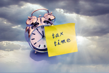 alarm clock with tax time and cloudy sky