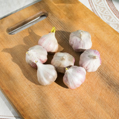 Garlic cloves  on a vintage wooden background.