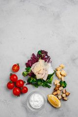 Caesar salad ingredients on a light background