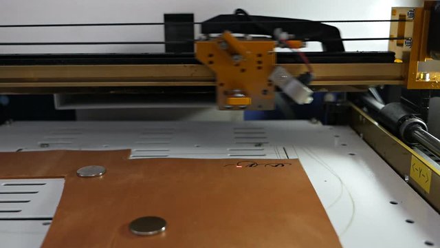 Laser engraving machine work,skin logo. Leather purse